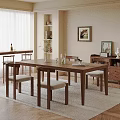Elegant Dining Space With Wooden Table Chairs Vase Glassware Cabinet Artwork And Plant