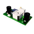 Electronic Circuit Board With Green PCB Black Capacitors And White Components