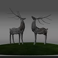 Silver Deer Sculptures Standing On Green Grass Against Light Blue Sky