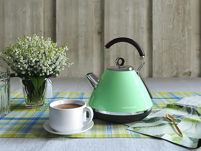 Green Electric Kettle for Daily Use on Checkered Tablecloth with Coffee Cup and White Flowers 3d model
