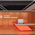 Modern Fitness Reception Desk With Orange Wall Neon Lighting And Computer Setup