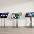Three Standing Touchscreen Displays Showing Various Content With Wooden Floor And White Wall