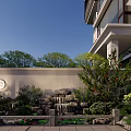Traditional Chinese Garden Landscape with Rockery Waterfall Circular Window Stone Wall and Green Plants