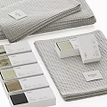 Grey Waffle Textured Towels Neatly Stacked With Decorative Gift Boxes
