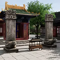 Traditional Chinese Ancient Architecture With Green Roof Yellow Eaves And Stone Lion Statues In Courtyard