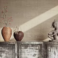 Vintage Console Cabinet with Three Textured Doors Decorated with Vases Sculpture and Light Shadows