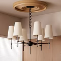 Modern Chandelier With Multiple White Fabric Shades And Black Metal Frame Hanging From Ceiling