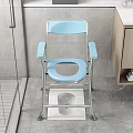 Blue Folding Toilet Chair In Bathroom With Non Slip Mat And Wooden Cabinet