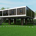 Modern Elevated Building With Glass Windows And Pillars On Green Lawn