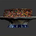 Chocolate Cake With Golden Cream Topping And Colorful Sprinkles On Blue And White Plate