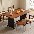 Wooden Dining Table With Black Legs And Chairs Beige Orange Cushions White Vase Oranges Books