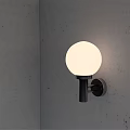 Minimalist Modern Wall Lamp on Gray Concrete Wall with White Spherical Lampshade and Black Pole