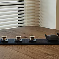 Traditional Tea Set With Black Tray Teapot And Three Teacups On Wooden Table