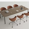 Wooden Conference Table With Orange Rolling Chairs Laptops Printer Coffee Cups And Documents