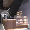 Modern Café Interior Featuring Wooden Counter Glass Display Case Fresh Pastries Staircase And Neon Lighting