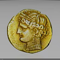 Ancient Gold Coin Featuring Head With Curly Hair Headdress And Golden Surface