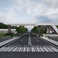 Modern Entrance Gate With Wide Road Railings And Greenery Under Cloudy Sky