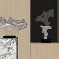 Modern Silver Sculptures On Marble Bases Against Wooden Wall With Vertical Stripes