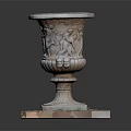 Small Grass Plants In Carved Stone Planter On Square Base With Pebbles
