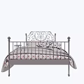 Double Bed With Wrought Iron Frame Ornate Headboard Floral Pillows And Gray Throw Blanket