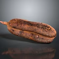 Whole Brown Textured Tropical Fruit With Fresh Organic Look On Black Background With Reflection