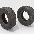 Two Worn Rubber Tires With Deep Tread Patterns And Weathered Surface