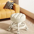 White Round Tufted Stool With Wheels On Striped Rug In Living Room