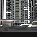 Modern Entrance Gate In Front Of High Rise Buildings With Greenery And Paved Plaza
