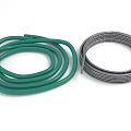 Green Flexible Hose And Silver Metal Coil In Coiled Form For Multiple Applications