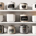 Various Design Electric Rice Cookers And Pressure Cookers Displayed On Shelves