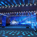 Event Stage With Blue Lights LED Screens And Star Floor