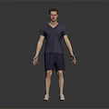 Man in V neck T shirt and shorts standing with sneakers on dark background