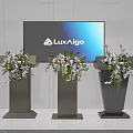 Three Modern Podiums With LuxAlgo Screen And Decorative Flower Arrangements