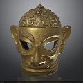 Intricate Golden Mask Sculpture With Detailed Carving Patterns And Decorative Top