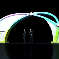 Colorful Gradient Archway with Top Lights and Two Men in Suits at Summit