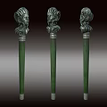 Three Ancient Decorative Weapons Featuring Carved Head Tops And Green Shafts