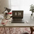 Desk Setup With Laptop Desk Lamp Books Headphones And Flower Vase On Rug