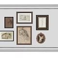 Wall Decor With Various Framed Artworks And Sketches On White Wall