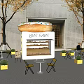 Dessert Shop with Giant Donut Sign Outdoor Yellow Tables Chairs and Trees Around White Kiosk
