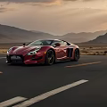 Red Sports Car Driving On Mountain Road During Sunset With Scenic Landscape