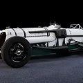 Vintage White Race Car With Open Design And Exposed Mechanical Parts On Gray Surface