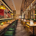 Restaurant Interior With Red Slogan Yellow Pendant Lights Wooden Tables Green Seats And Wall Decorations