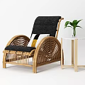 Rattan Leisure Chair with Black Cushion Decorative Pillow Side Table and Green Plant