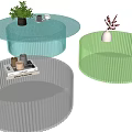 Modern Round Transparent Coffee Tables With Blue Green Clear Colors Featuring Plants Vase Books Cups