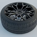 Car Tire with Black Geometric Alloy Wheel and Tread Pattern Design