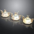 Three Ornate Winged Containers With Gold Accents And Gemstone Decorations