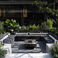 Modern Landscape Seating In Outdoor Garden With Lush Green Plants And Central Fire Pit