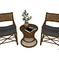Cozy Rattan Table And Chair Set With Gray White Cushions Potted Plant And Book