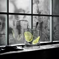 Refreshing Glass Of Beverage With Lime Slices Ice Cubes On Window Sill In Natural Light