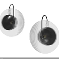 Modern Circular Wall Sconces With Striped Metallic Shade And Warm Ambient Lighting